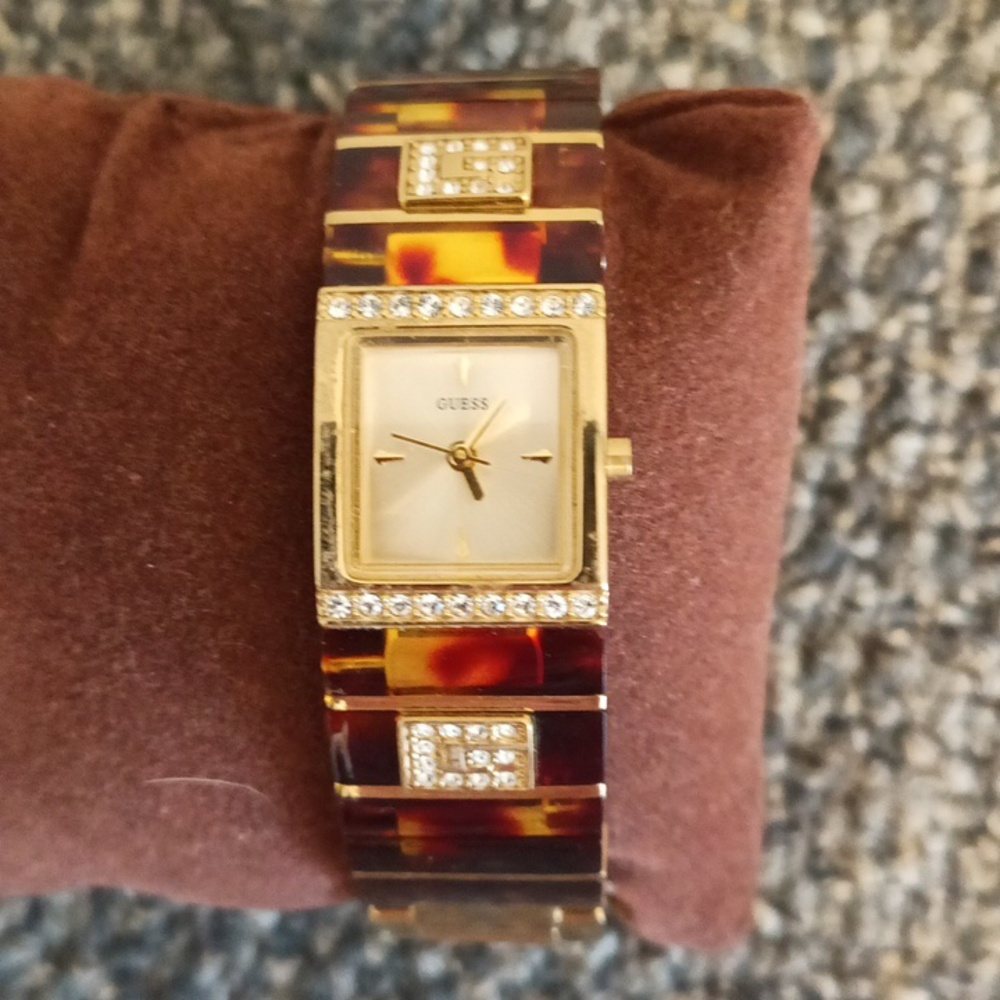 Guess gold tone crystal and tortoise shell womens iconic bracelet watch